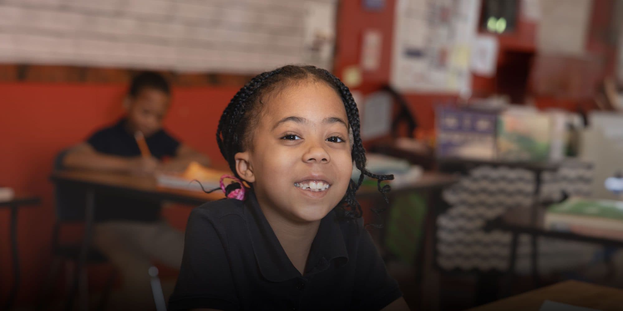 Smiling elementary student working at desk