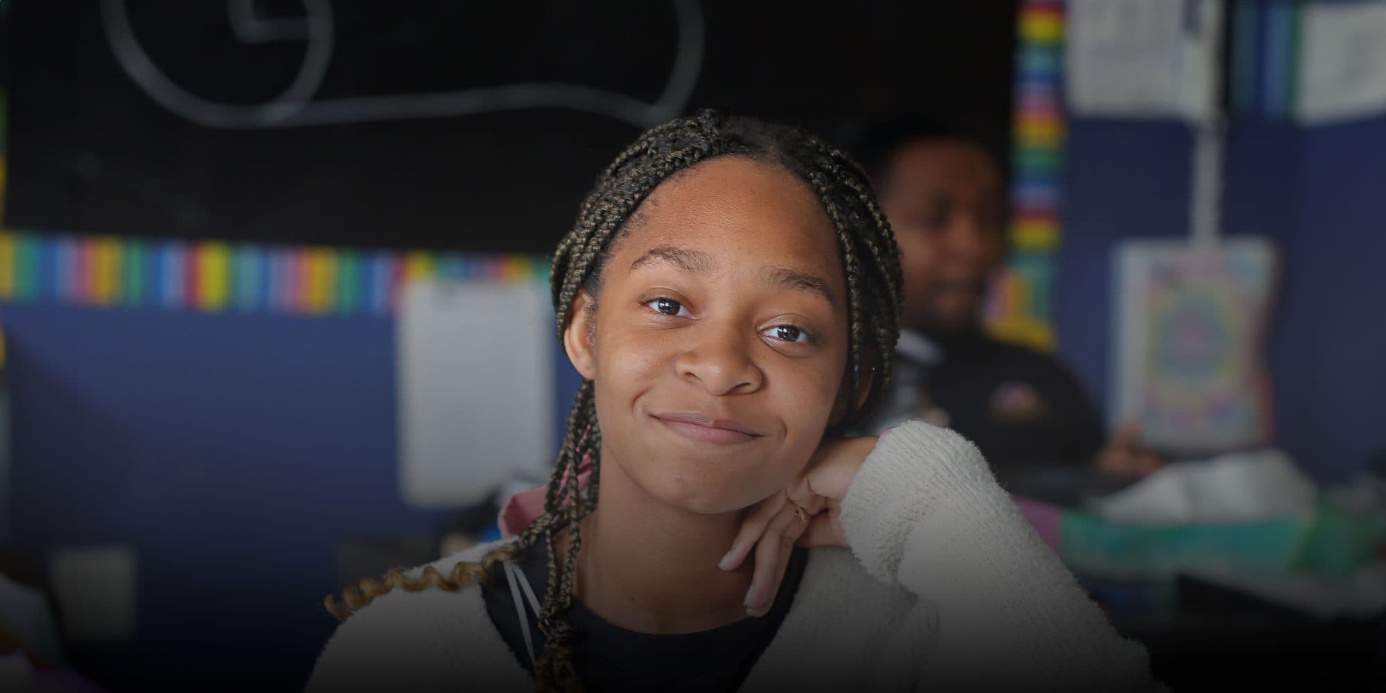 Smiling student sitting at desk